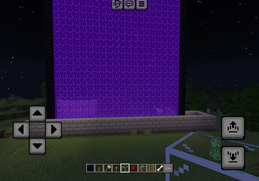 Minecraft gold farm at night with a giant glowing purple Nether portal towering above a stone brick collection channel. A creeper stands nearby on the grass.